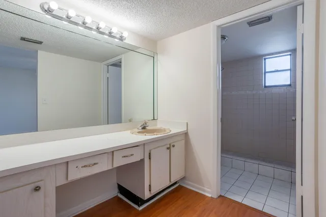 a spacious bathroom with a sink and a mirror