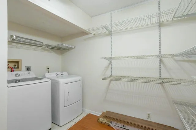 a view of storage and utility room with washer and dryer