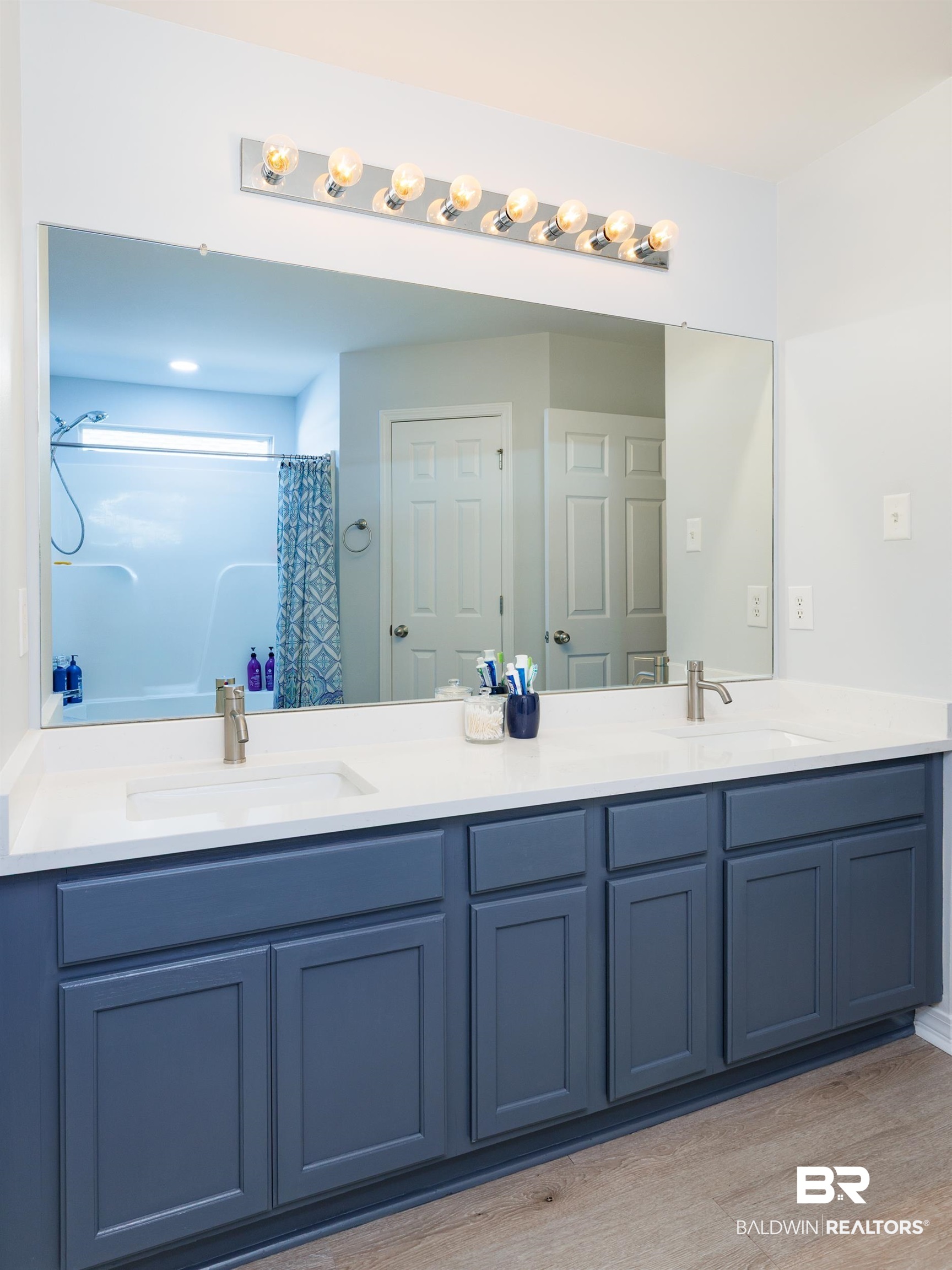 16227 Zenith Drive Loxley, AL 36551 - Photo 14 of 23 Full bathroom with double vanity, a shower with curtain, and light wood finished floors
