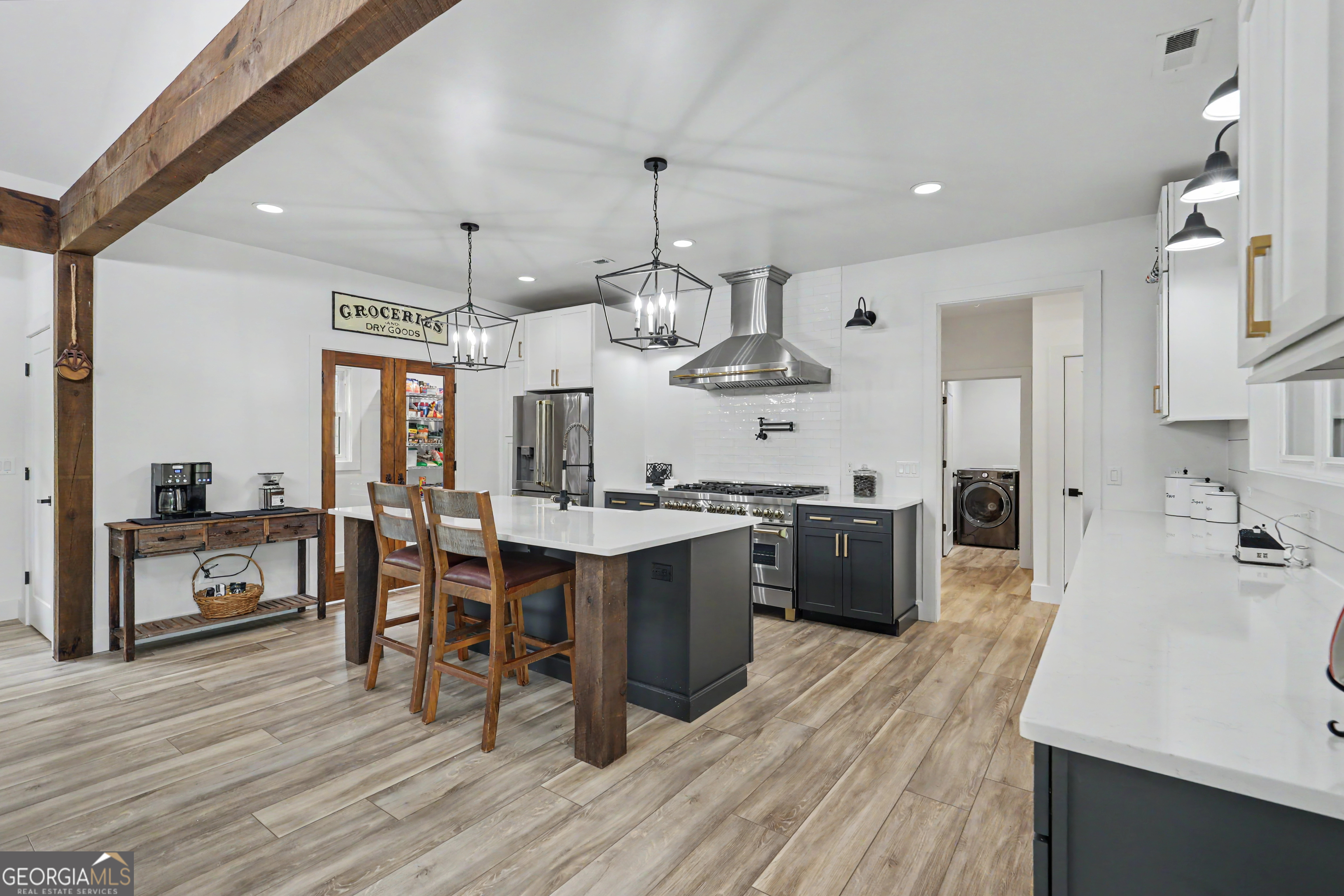 1424 Ridge Pointe Way Blairsville, GA 30512 - Photo 15 of 114 a kitchen with stainless steel appliances granite countertop a kitchen island a stove a refrigerator a sink dishwasher a dining table and chairs with wooden floor