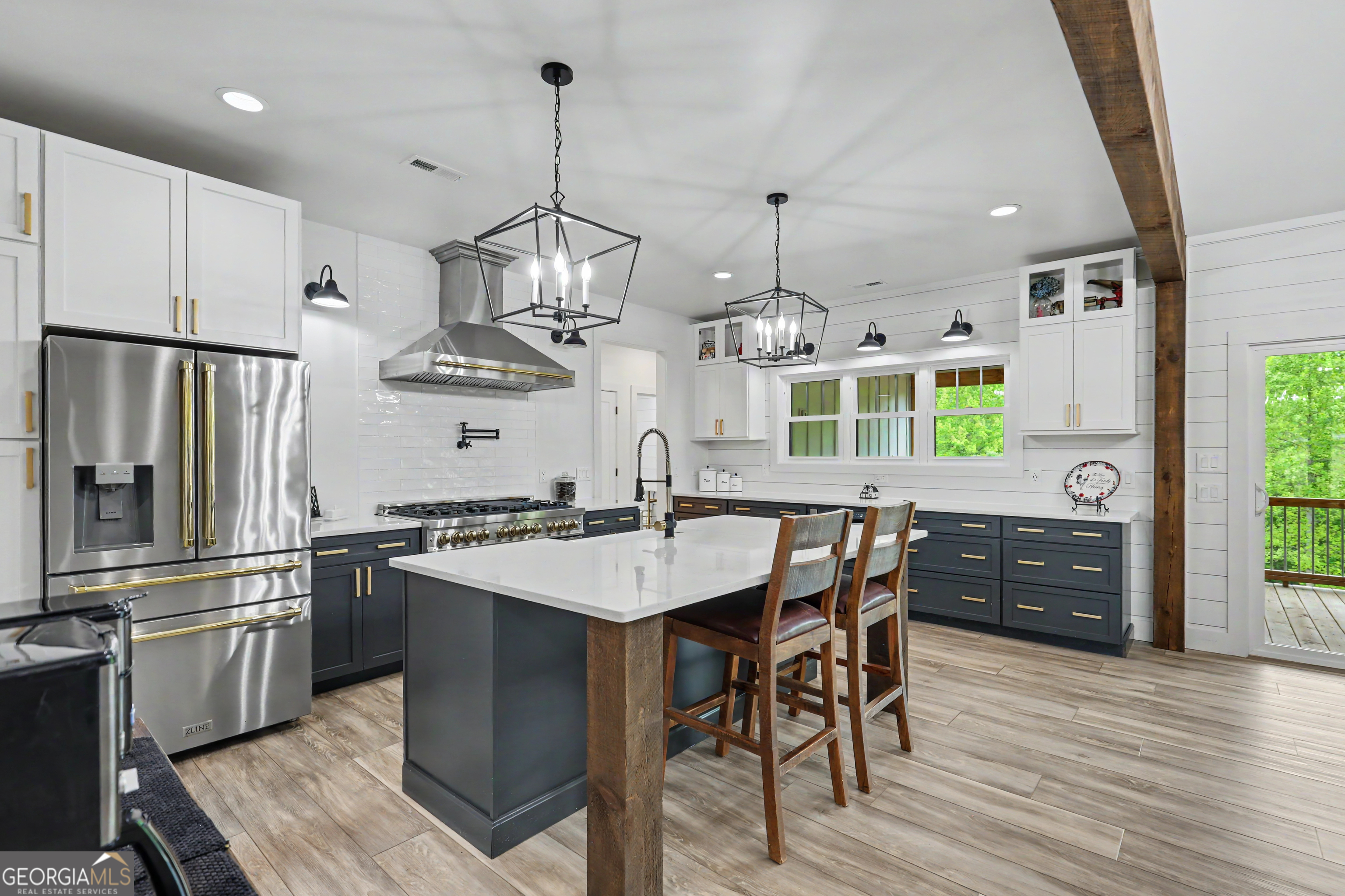1424 Ridge Pointe Way Blairsville, GA 30512 - Photo 16 of 114 a kitchen with stainless steel appliances kitchen island granite countertop a refrigerator a sink dishwasher a stove and a dining table with wooden floor
