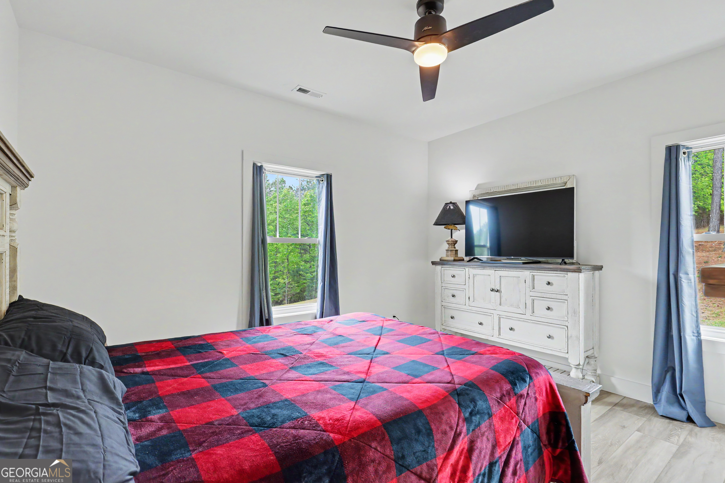 1424 Ridge Pointe Way Blairsville, GA 30512 - Photo 24 of 114 a bedroom with a bed and a flat screen tv