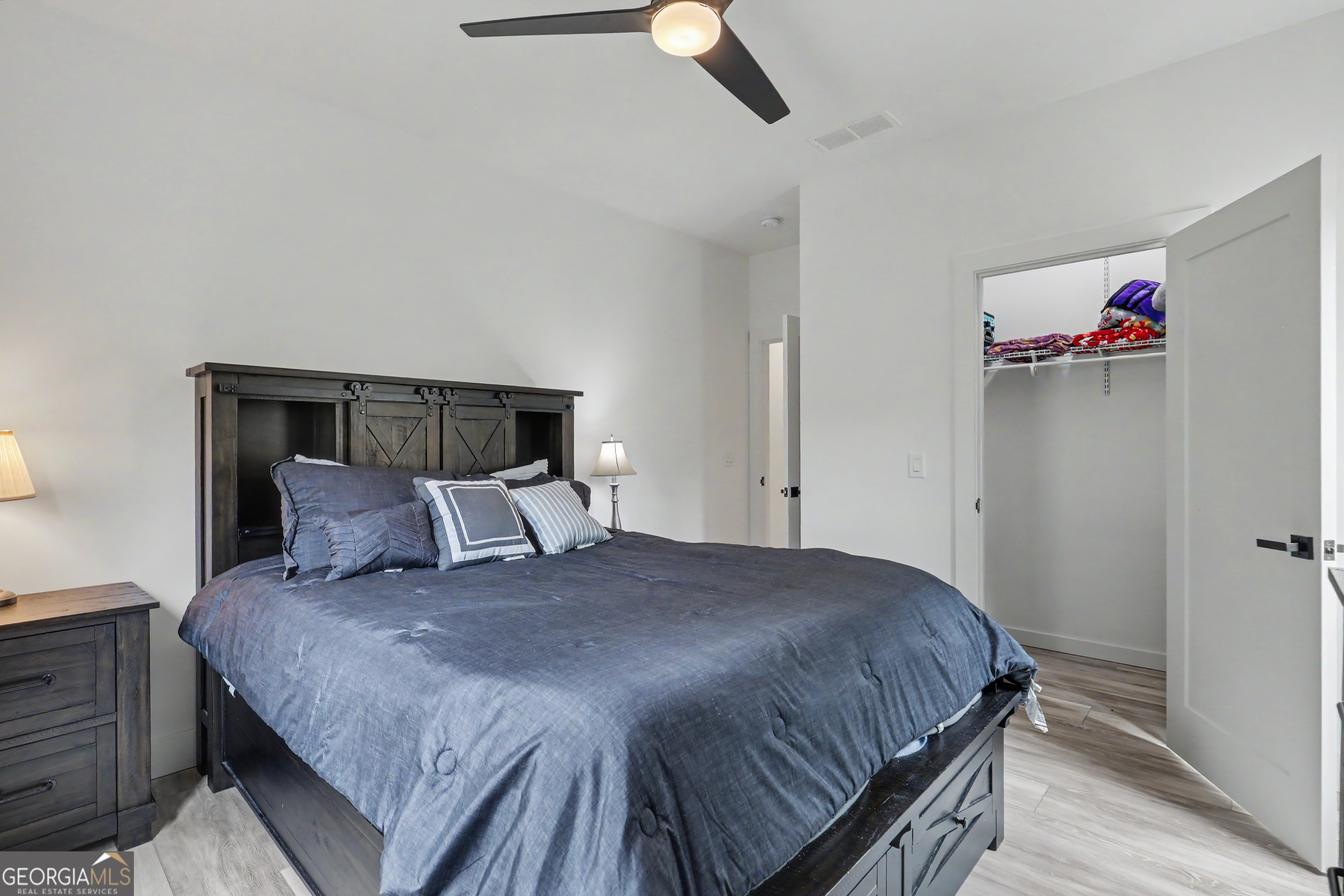 1424 Ridge Pointe Way Blairsville, GA 30512 - Photo 27 of 114 a bedroom with a bed and a chandelier