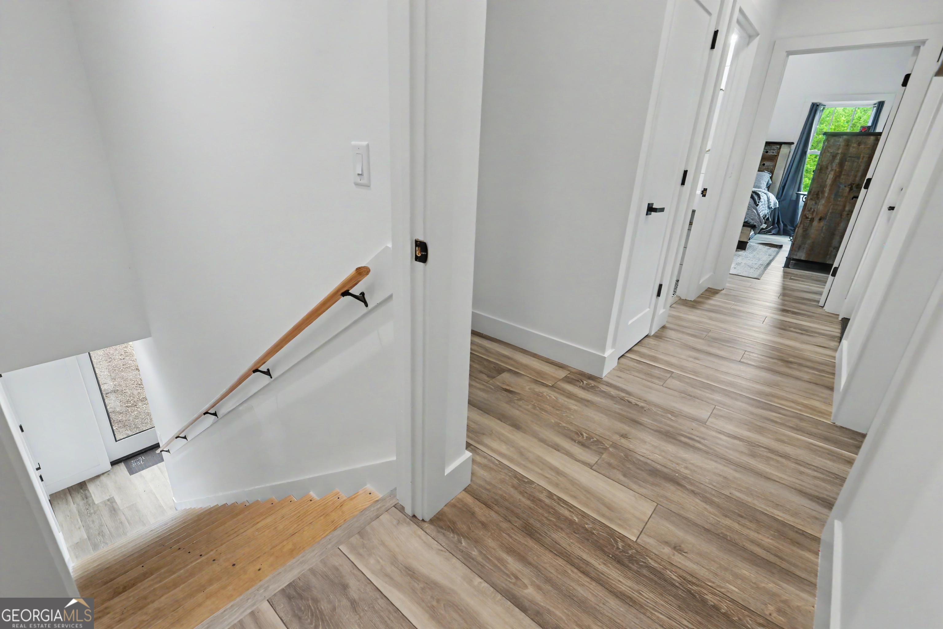1424 Ridge Pointe Way Blairsville, GA 30512 - Photo 60 of 114 a view of a hallway with wooden floor and staircase