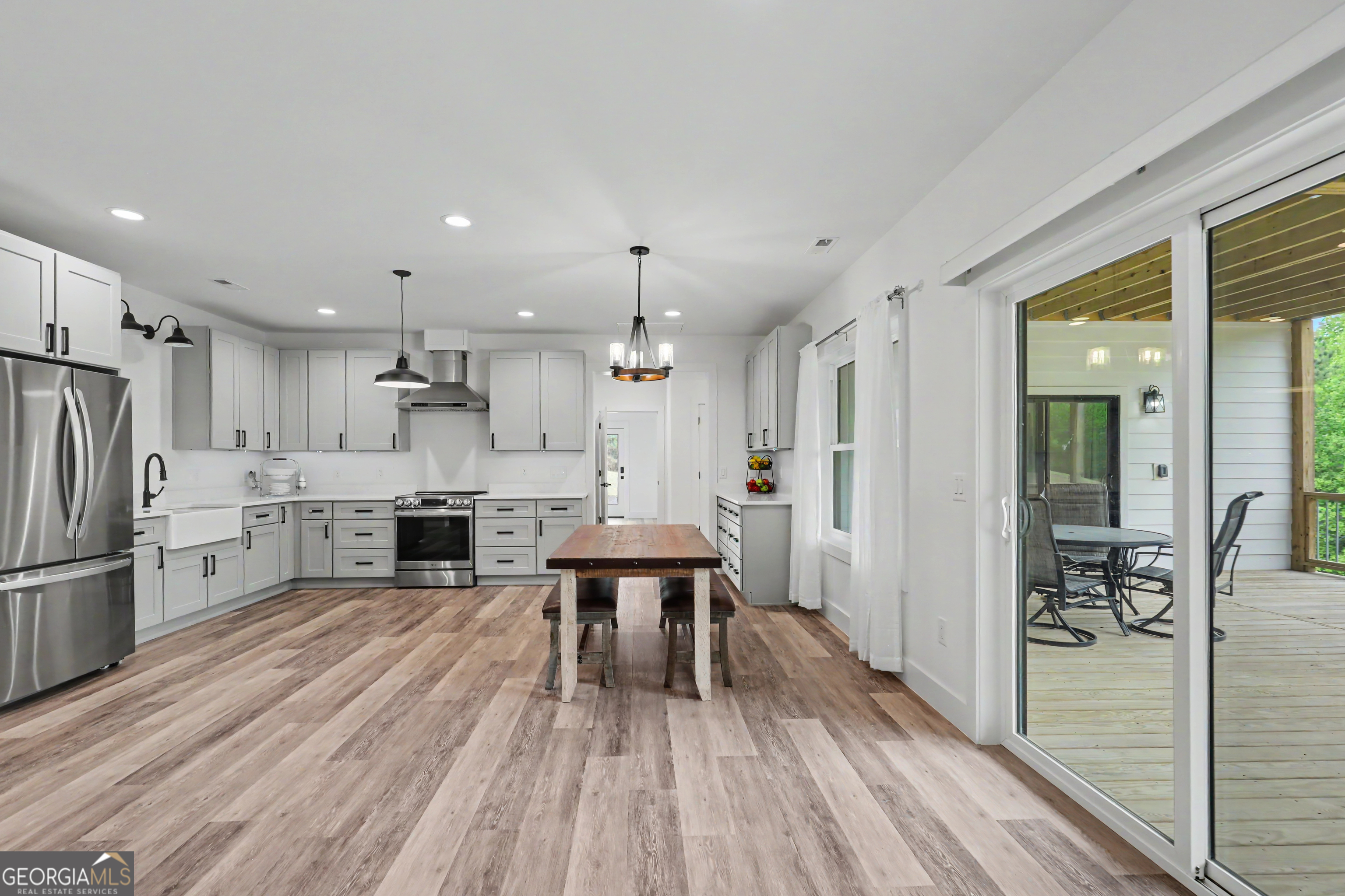 1424 Ridge Pointe Way Blairsville, GA 30512 - Photo 66 of 114 a kitchen with stainless steel appliances refrigerator wooden floor dining table and chairs