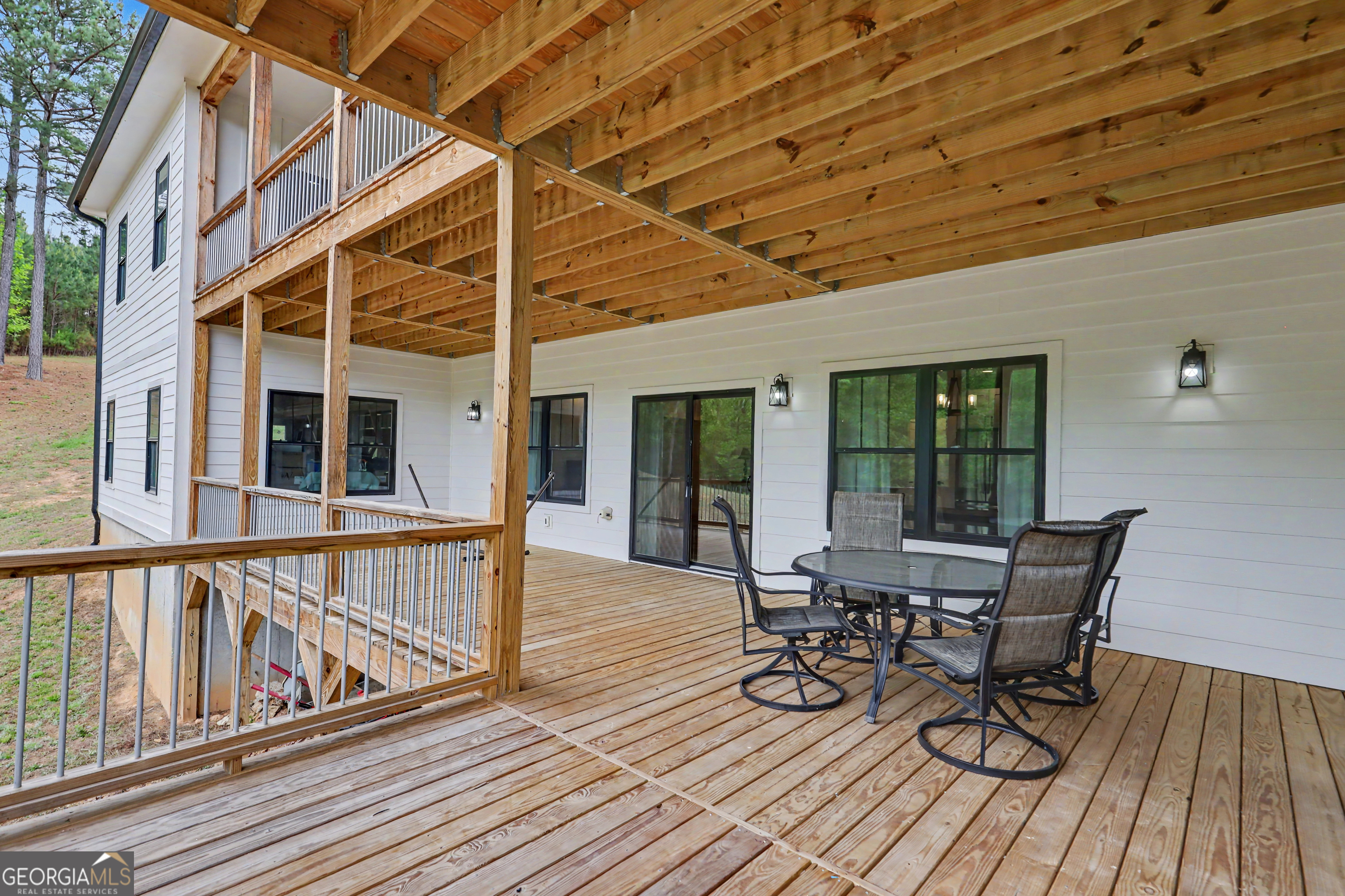 1424 Ridge Pointe Way Blairsville, GA 30512 - Photo 76 of 114 a view of a balcony with chairs and wooden floor
