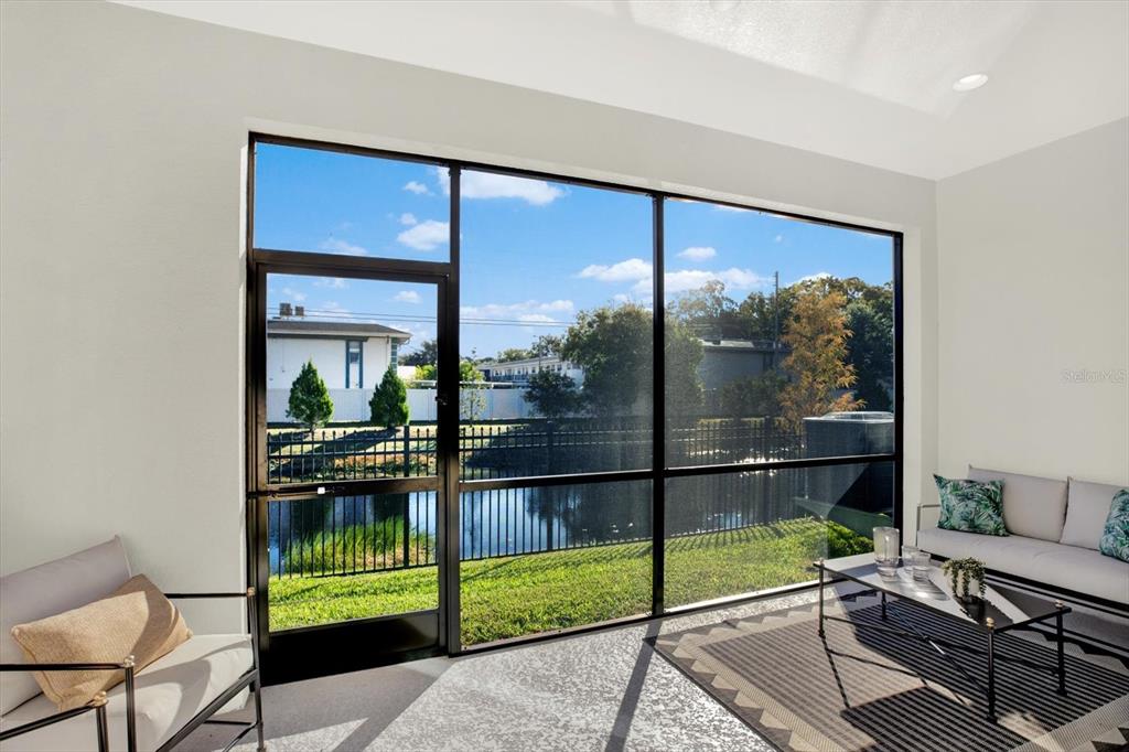 7765 93rd Street North Seminole, FL 33777 - Photo 14 of 29 a room with sliding glass door and glass door