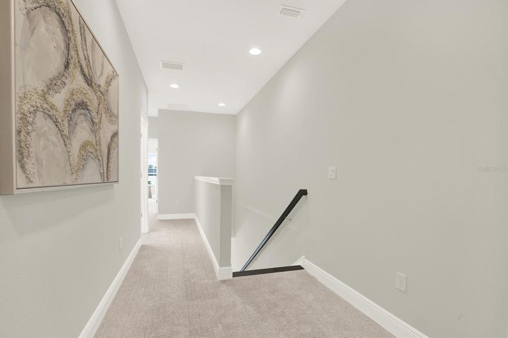7765 93rd Street North Seminole, FL 33777 - Photo 15 of 29 a view of a hallway with staircase