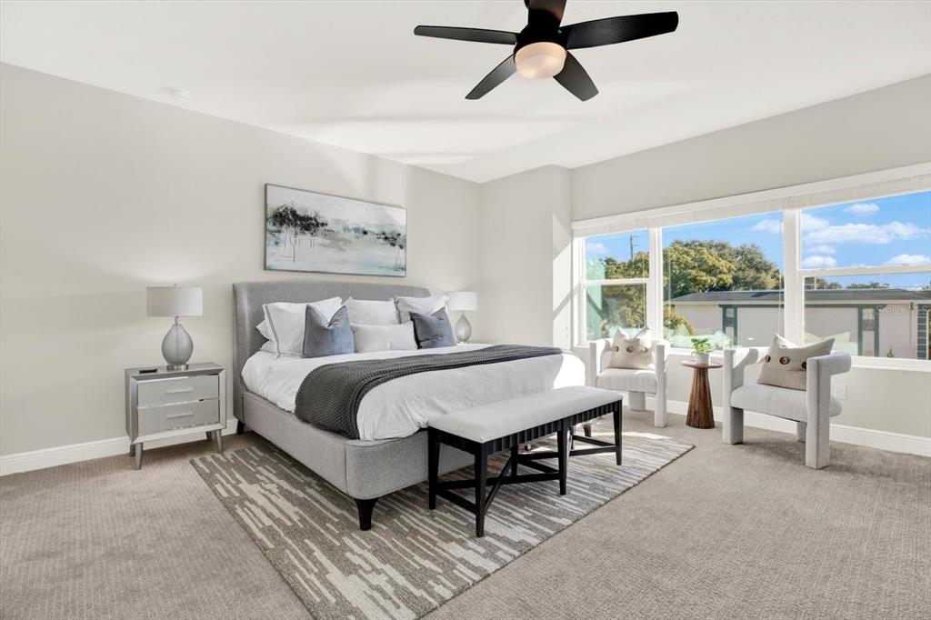 7765 93rd Street North Seminole, FL 33777 - Photo 16 of 29 a bedroom with furniture and a large window