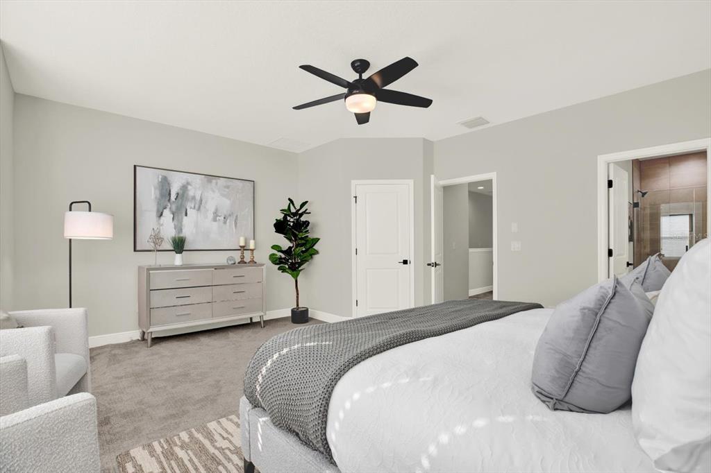 7765 93rd Street North Seminole, FL 33777 - Photo 18 of 29 a bedroom with a large bed and a chandelier