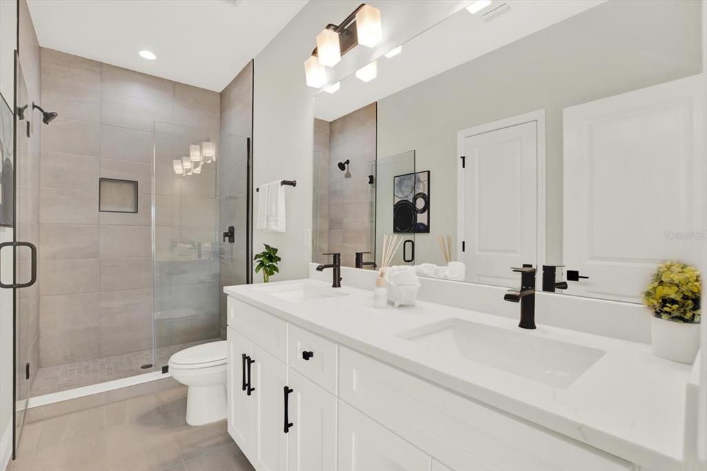 7765 93rd Street North Seminole, FL 33777 - Photo 20 of 29 a bathroom with a sink a toilet and shower