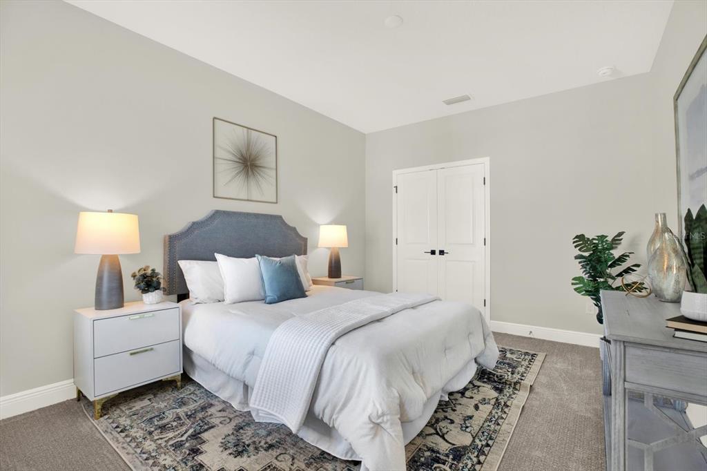 7765 93rd Street North Seminole, FL 33777 - Photo 21 of 29 a bedroom with a large bed and a potted plant