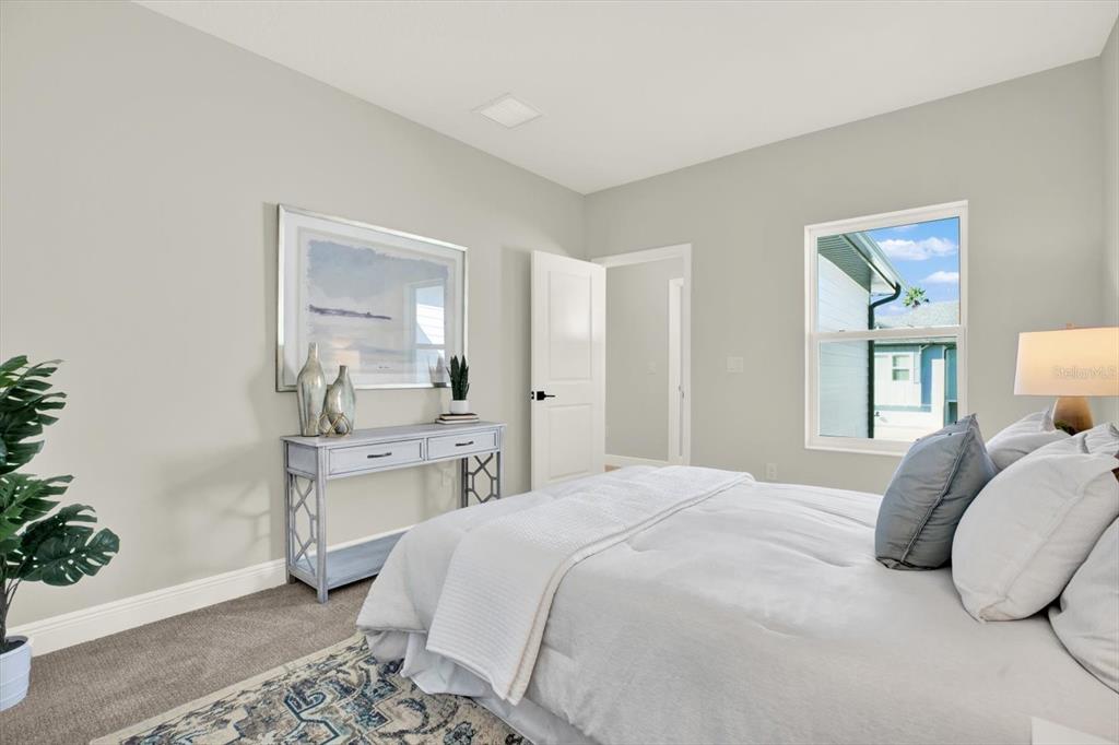 7765 93rd Street North Seminole, FL 33777 - Photo 22 of 29 a bedroom with a bed and a chandelier