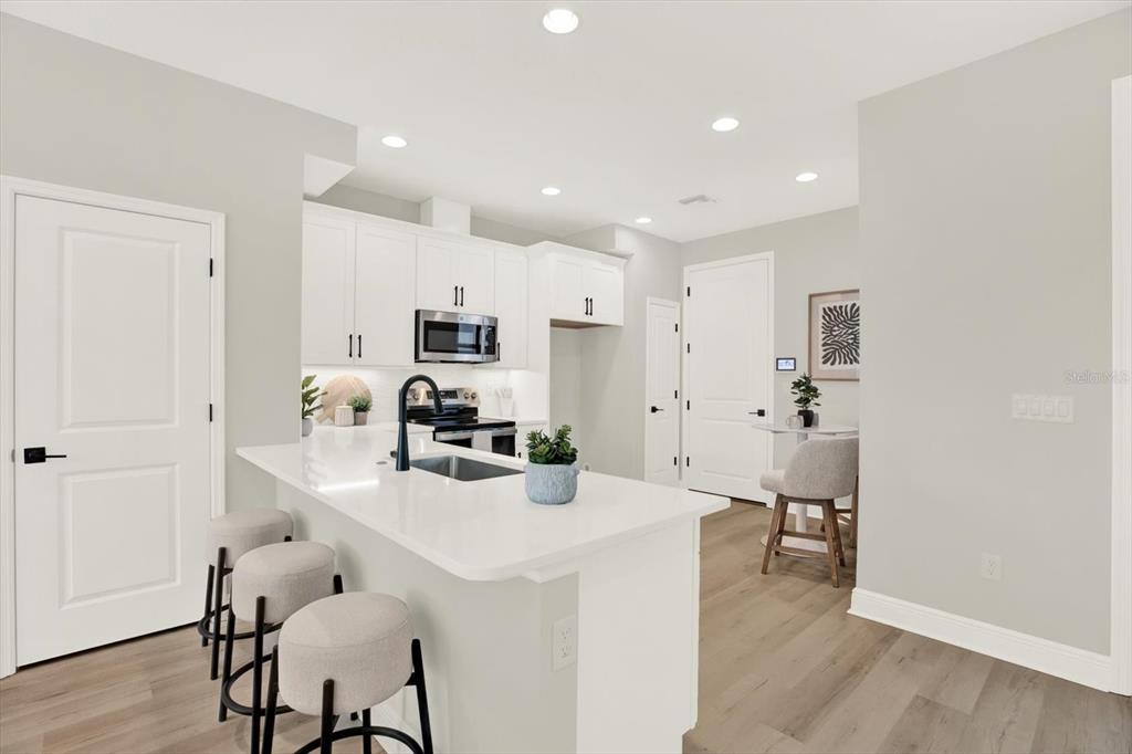 7765 93rd Street North Seminole, FL 33777 - Photo 4 of 29 a kitchen with kitchen island a appliances dining table and chairs