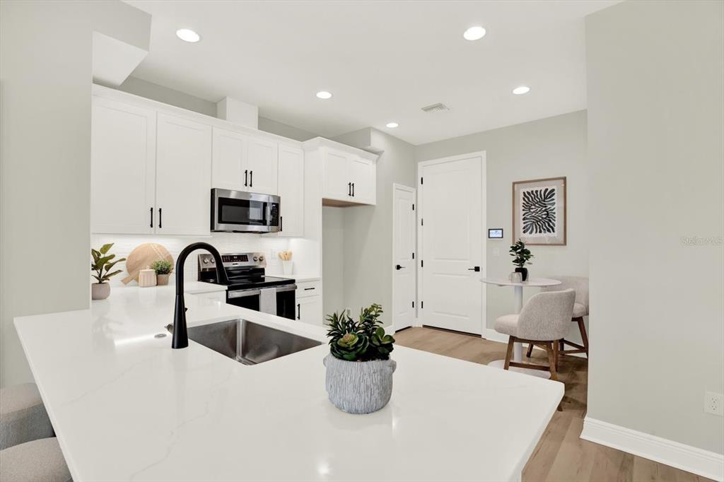 7765 93rd Street North Seminole, FL 33777 - Photo 6 of 29 a kitchen with a refrigerator and a sink