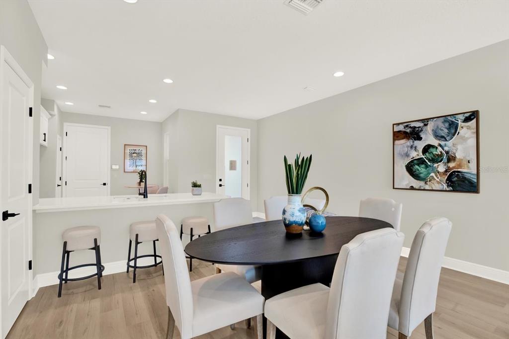 7765 93rd Street North Seminole, FL 33777 - Photo 9 of 29 a view of a dining room with furniture and wooden floor
