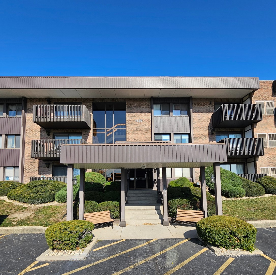 1420 Woodbridge Road, Unit 1E Joliet, IL 60436 - Photo 1 of 15 a view of building with roof deck