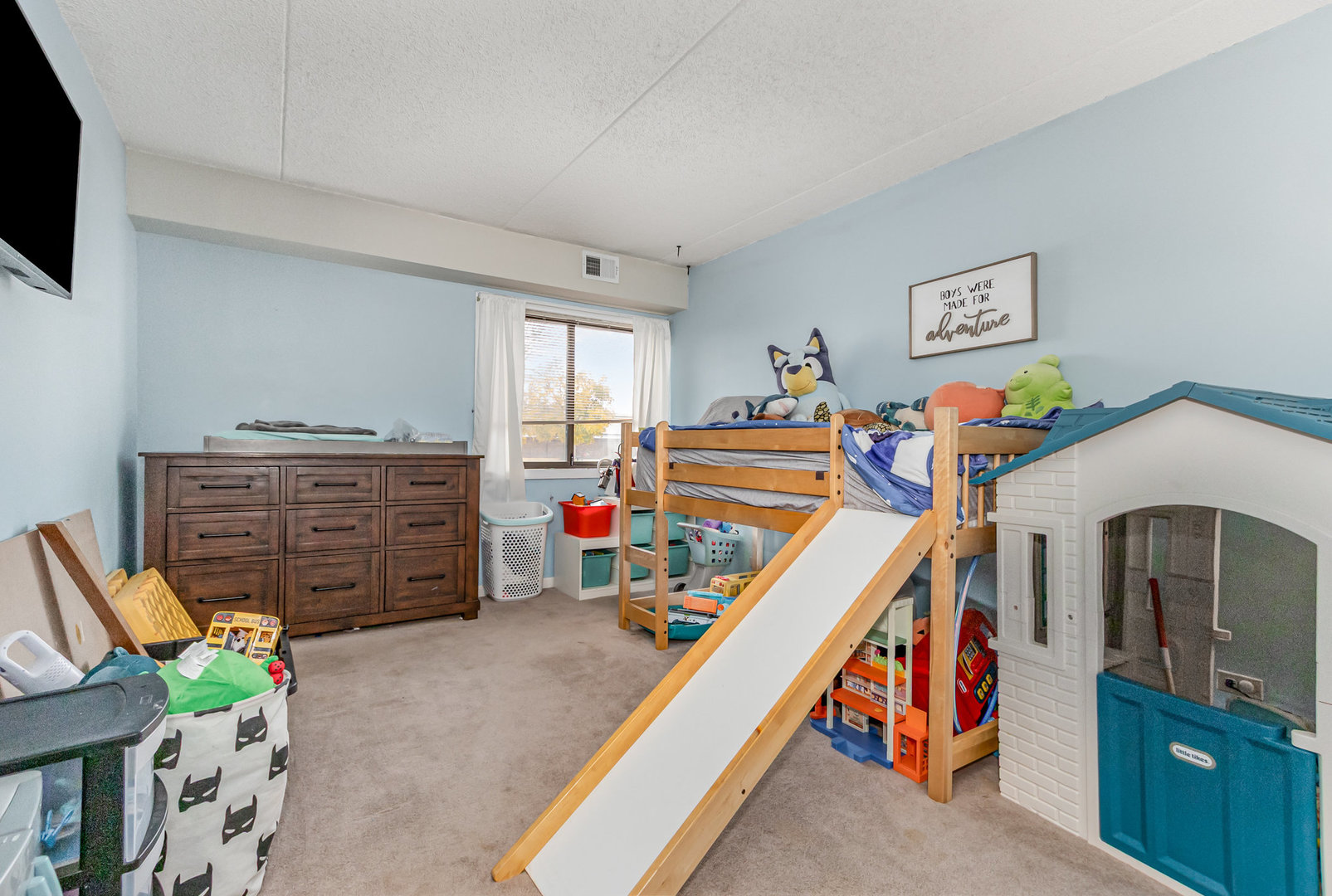 1420 Woodbridge Road, Unit 1E Joliet, IL 60436 - Photo 11 of 15 a bed room with a bed and a television