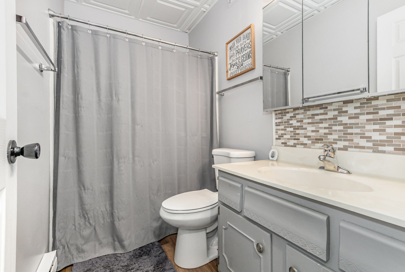 1420 Woodbridge Road, Unit 1E Joliet, IL 60436 - Photo 12 of 15 a bathroom with a sink a toilet and shower