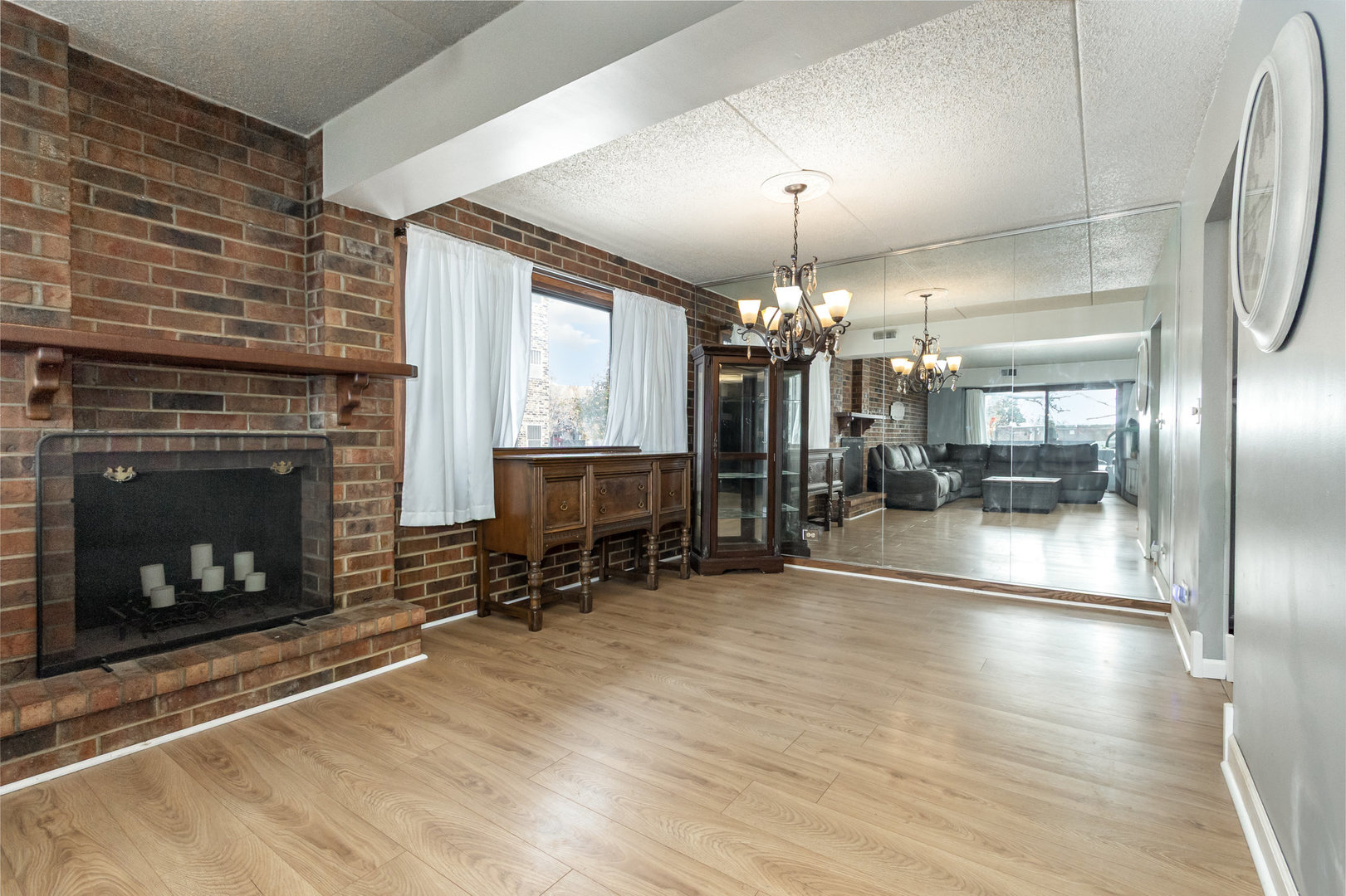 1420 Woodbridge Road, Unit 1E Joliet, IL 60436 - Photo 2 of 15 a room with fireplace and chandelier