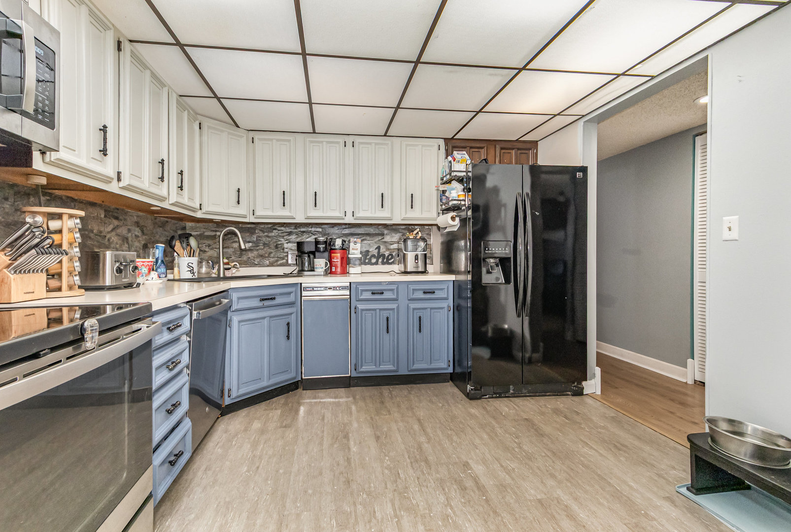1420 Woodbridge Road, Unit 1E Joliet, IL 60436 - Photo 5 of 15 a kitchen with stainless steel appliances granite countertop a refrigerator and a stove top oven