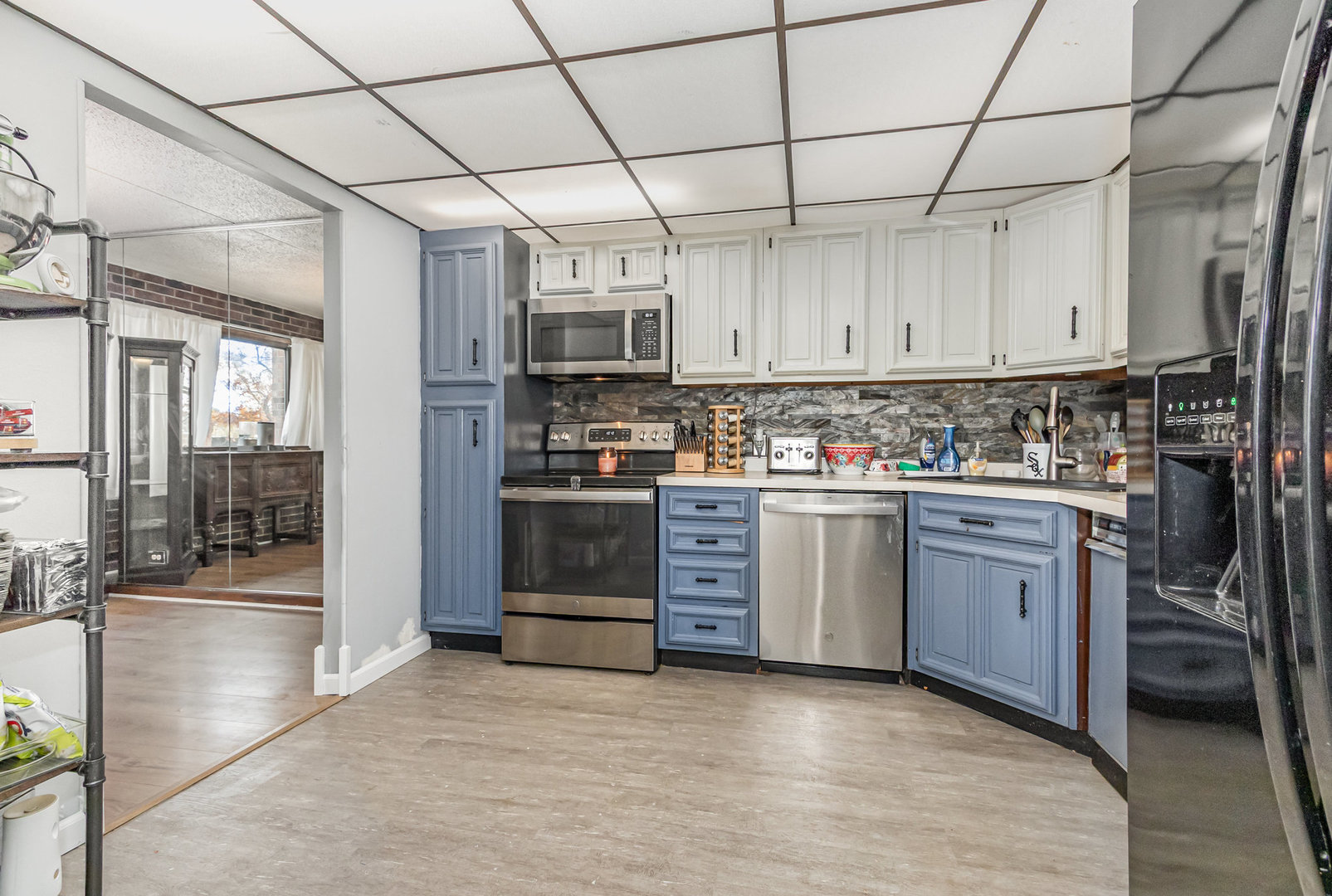 1420 Woodbridge Road, Unit 1E Joliet, IL 60436 - Photo 6 of 15 a kitchen with stainless steel appliances granite countertop a refrigerator a stove top oven a sink and dishwasher