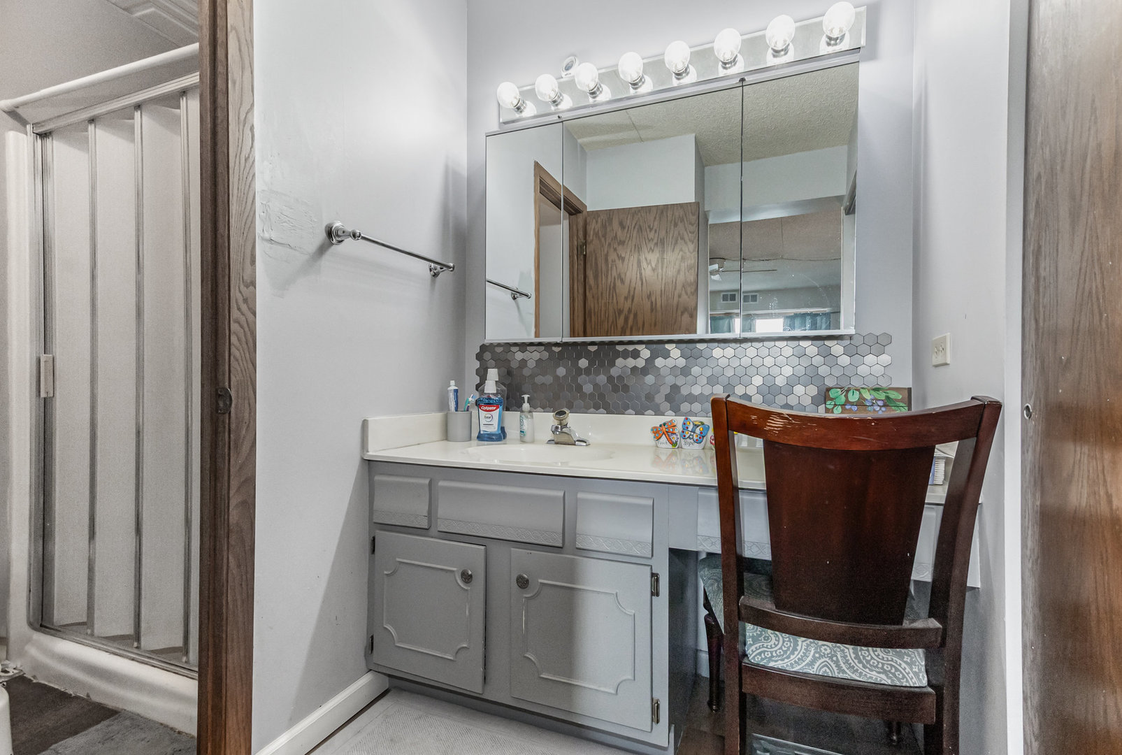 1420 Woodbridge Road, Unit 1E Joliet, IL 60436 - Photo 8 of 15 a bathroom with a granite countertop sink and a mirror
