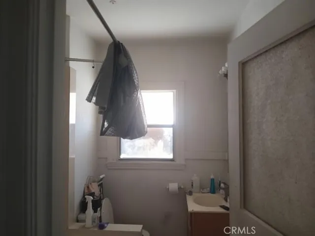 a bathroom with a toilet and a window