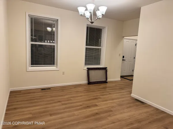 a bedroom with a bed and a flat screen tv on the dresser