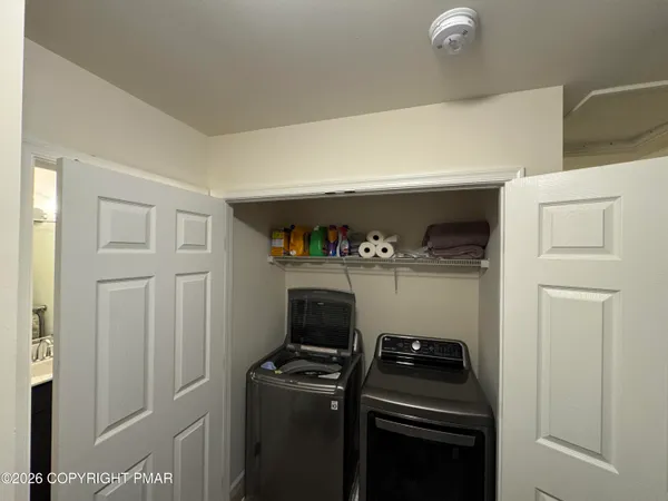 a bathroom with a double vanity sink and mirror with bathtub