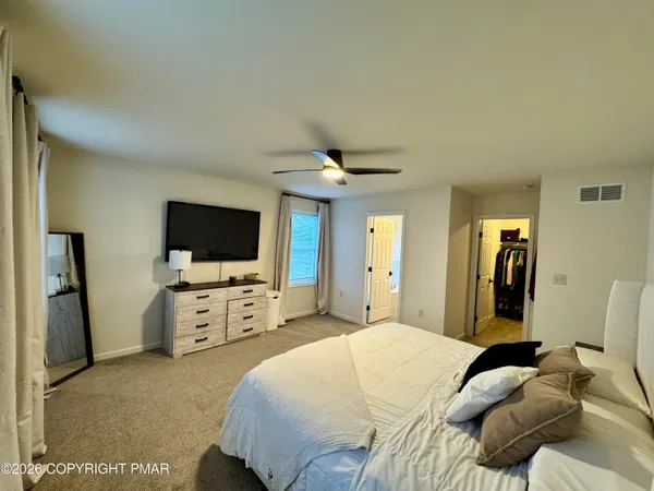 a bedroom with furniture and a window