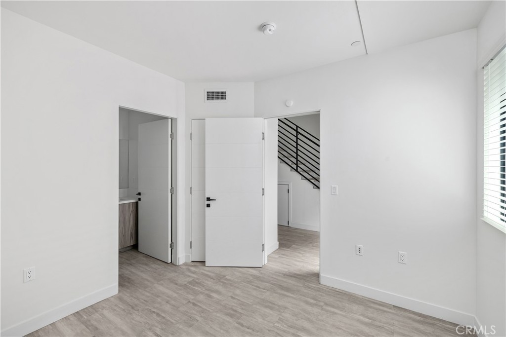 6719 Sepulveda Boulevard Van Nuys, CA 91406 - Photo 14 of 60 a view of an empty room with wooden floor