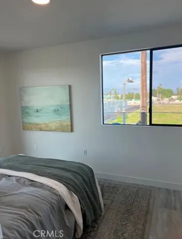 a bedroom with a bed window and couch