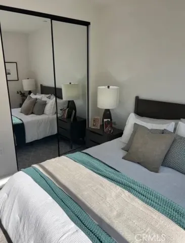 a bedroom with a bed and a mirror