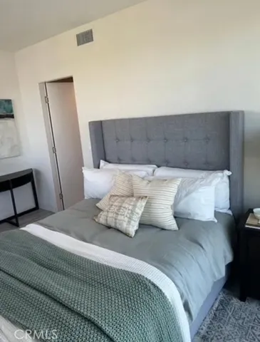 a bedroom with a bed and window