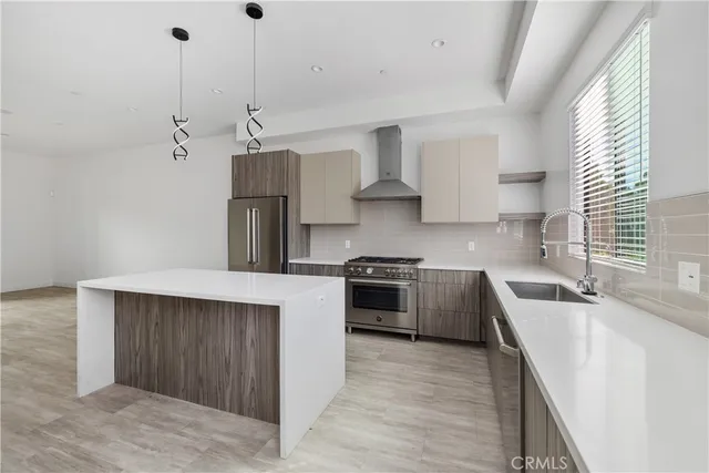 a kitchen with a stove and a refrigerator