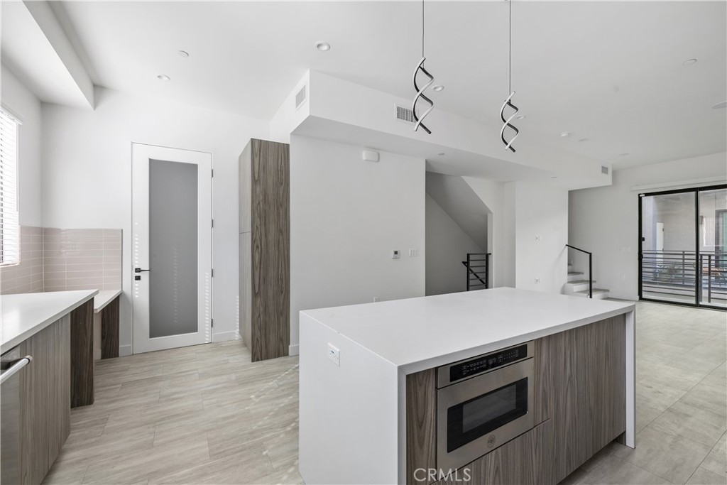 6719 Sepulveda Boulevard Van Nuys, CA 91406 - Photo 22 of 60 a kitchen with a stove and a refrigerator