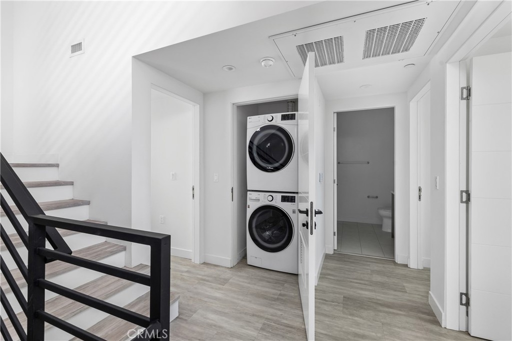 6719 Sepulveda Boulevard Van Nuys, CA 91406 - Photo 36 of 60 a view of a hallway with washer and dryer