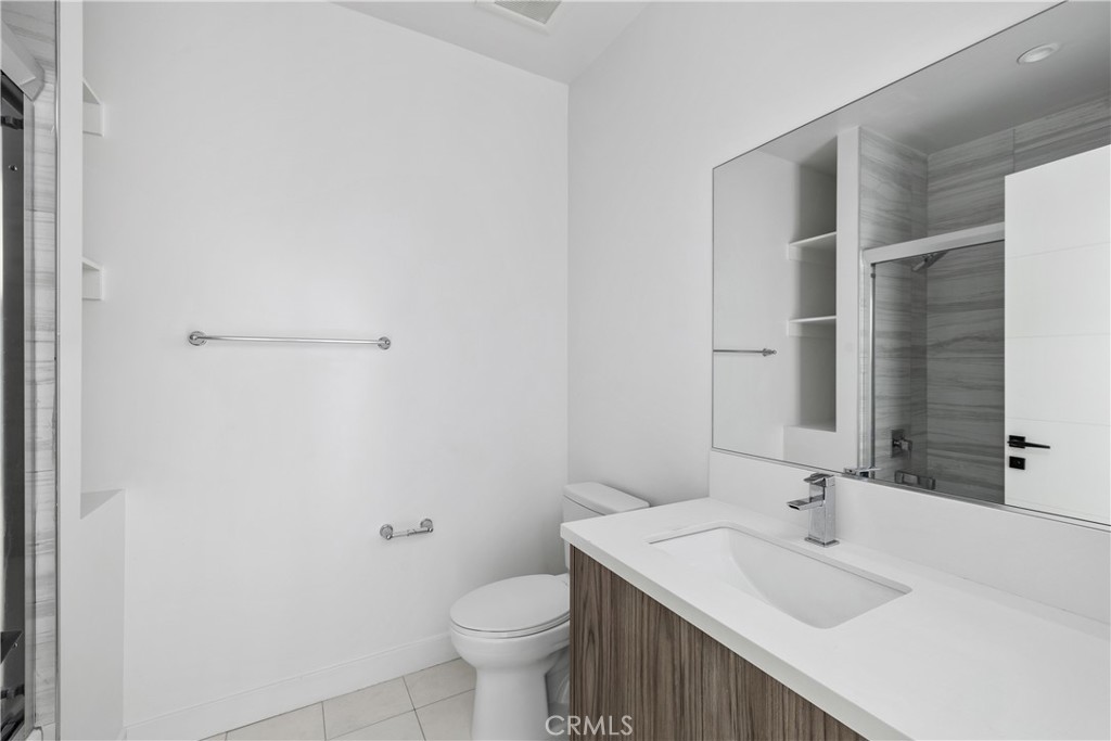 6719 Sepulveda Boulevard Van Nuys, CA 91406 - Photo 39 of 60 a bathroom with a sink and a toilet