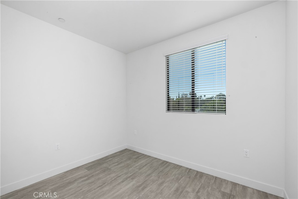 6719 Sepulveda Boulevard Van Nuys, CA 91406 - Photo 42 of 60 an empty room with wooden floor and windows