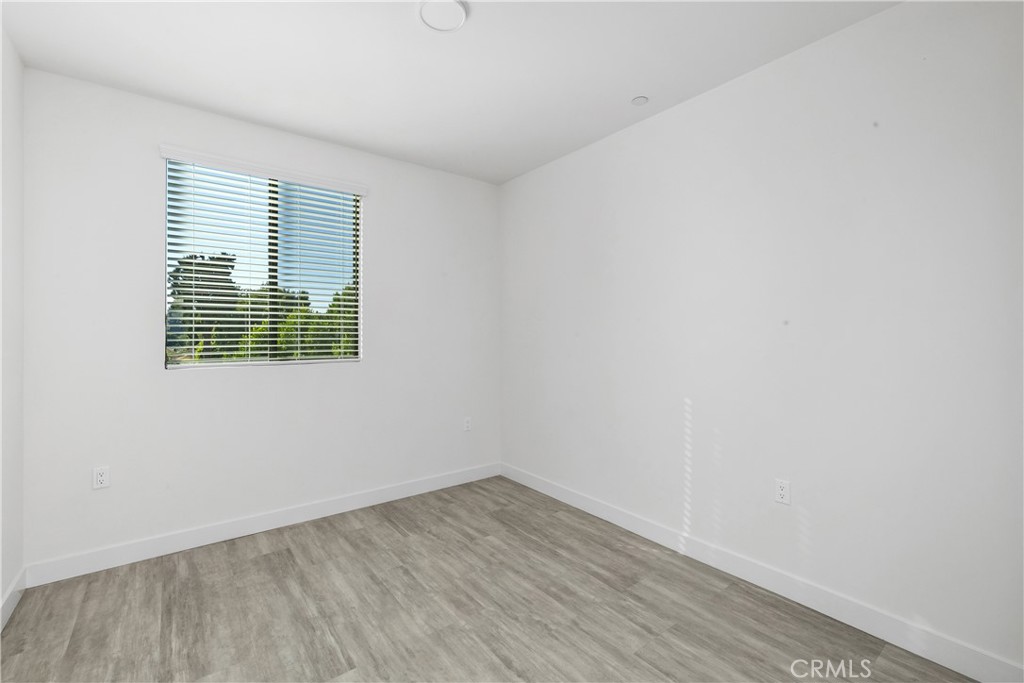 6719 Sepulveda Boulevard Van Nuys, CA 91406 - Photo 46 of 60 a view of an empty room with wooden floor and a window
