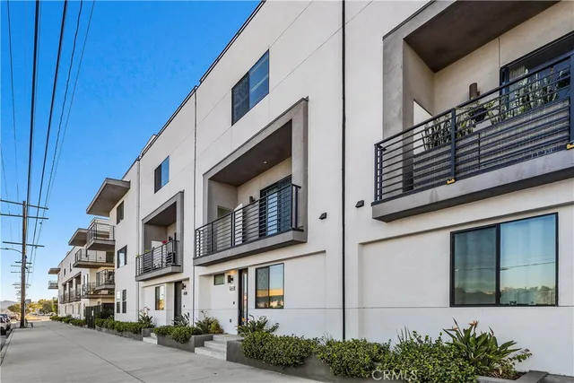 a view of a kitchen with wooden floor electronic appliances and window