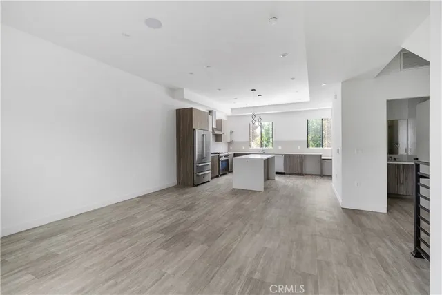 a view of a hallway with wooden floor and closet