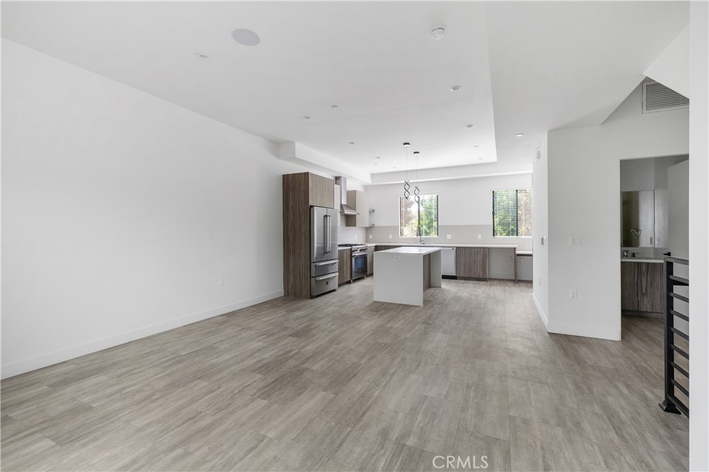 6719 Sepulveda Boulevard Van Nuys, CA 91406 - Photo 6 of 60 a view of a kitchen with wooden floor electronic appliances and window