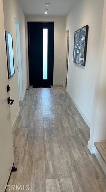 6719 Sepulveda Boulevard Van Nuys, CA 91406 - Photo 7 of 60 a view of a hallway with wooden floor and closet