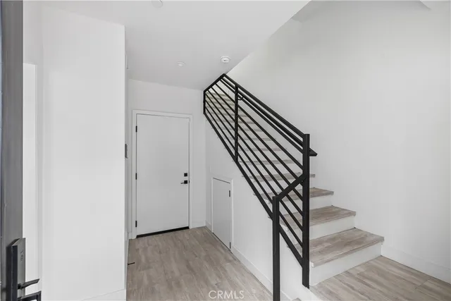 a kitchen with stainless steel appliances granite countertop a sink a stove a refrigerator and chairs