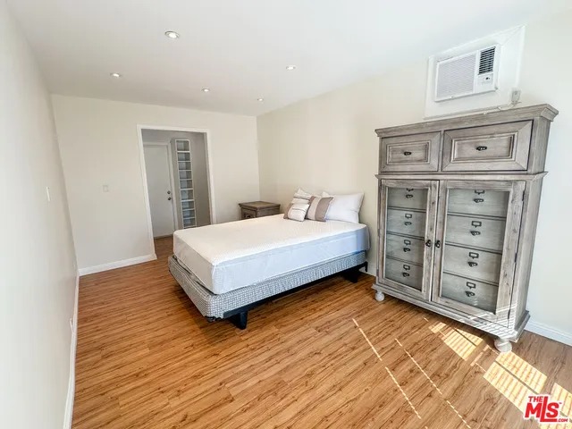 a bedroom with a bed and a cabinets