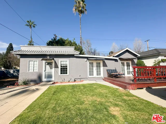 a front view of a house with a yard table and chairs