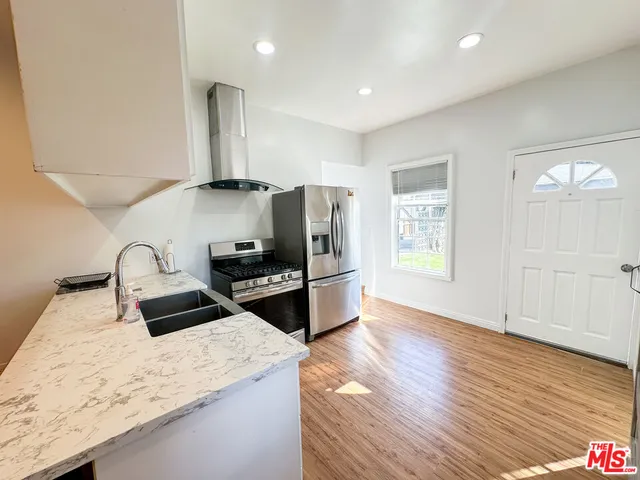 a kitchen with granite countertop a stove and a sink