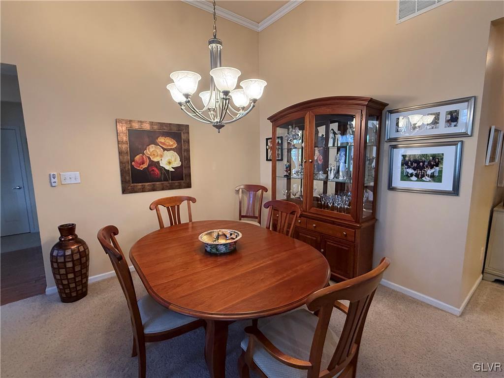 1847 Gregory Place Hellertown, PA 18055 - Photo 12 of 27 a view of a dining room with furniture a chandelier and wooden floor